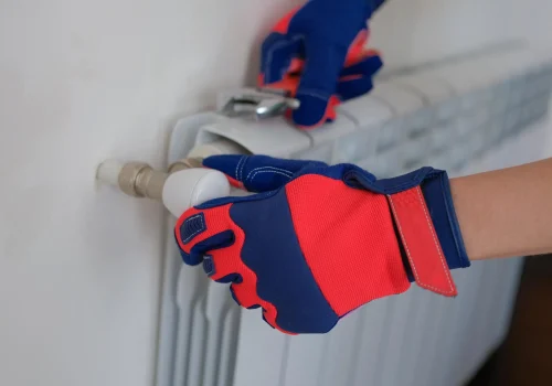 professional-repairman-mounting-water-heating-radiator-home-wall-fixing-problems-with-wate نصب و فروش پکیج و رادیاتور